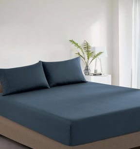 Montalcino indigo vintage washed cotton fitted sheet combo set on a bed