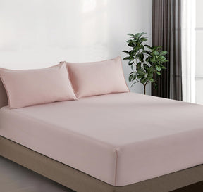 Volterra pink vintage washed microfibre fitted sheet set on a bed