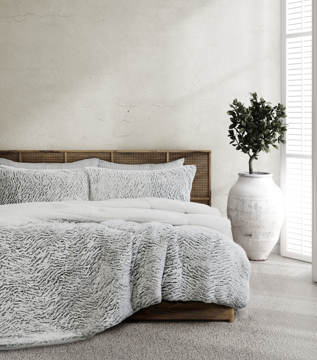 Kingswood faux fur and sherpa reversible comforter on a bed