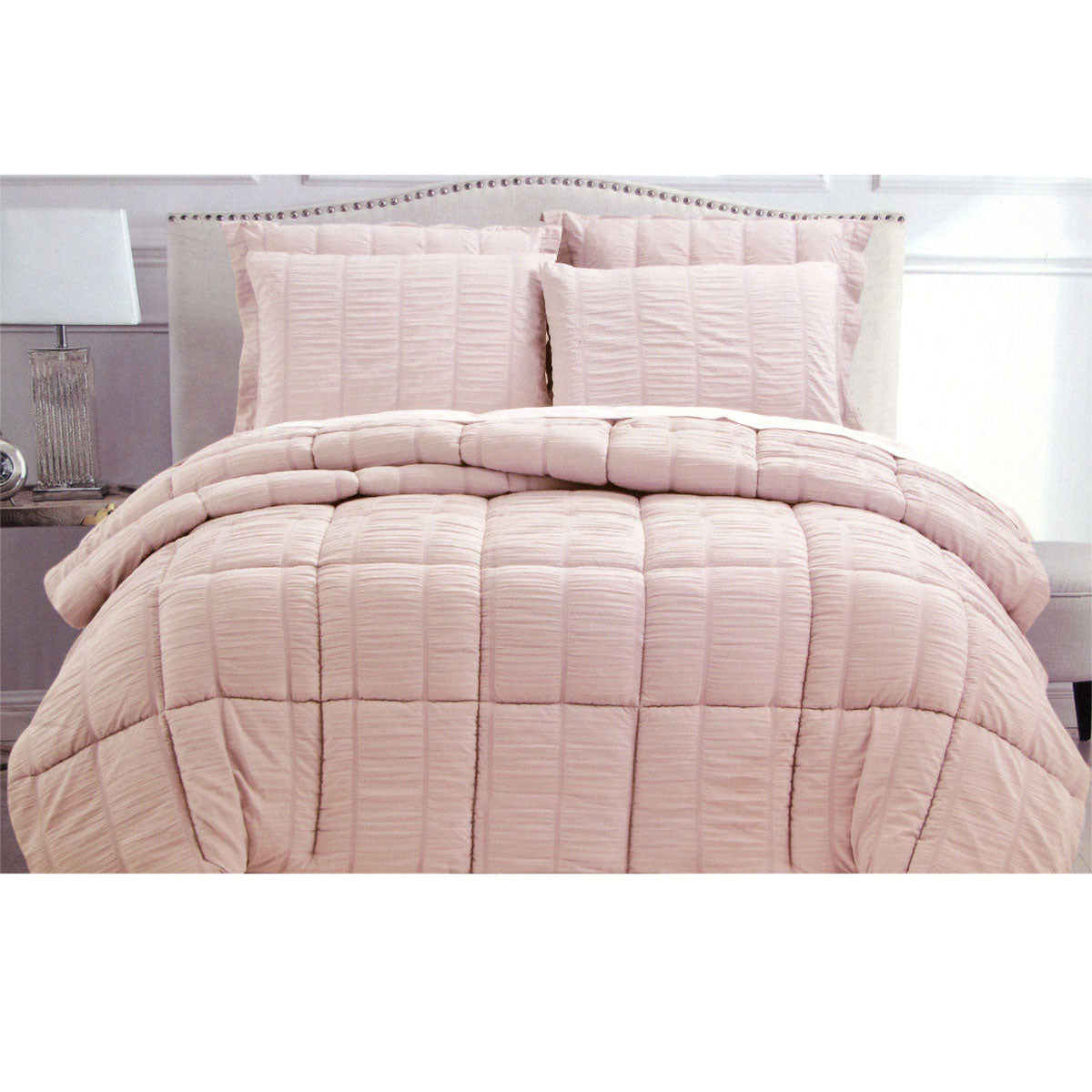 Whiteshill light pink seersucker comforter on a King bed
