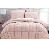 Whiteshill light pink seersucker comforter on a King bed