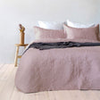 Dusk paisley embossed coverlet with two pillowcases on a Queen King bed