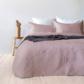 Dusk paisley embossed coverlet with two pillowcases on a Queen King bed