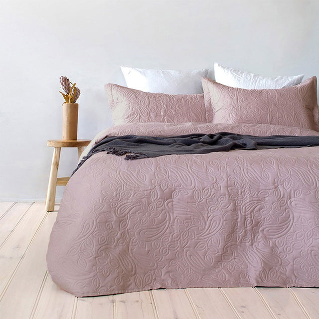Dusk paisley embossed coverlet with two pillowcases on a Queen King bed