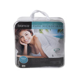 Light diamond quilted summer microfibre quilt in white with satin piping on a made double bed