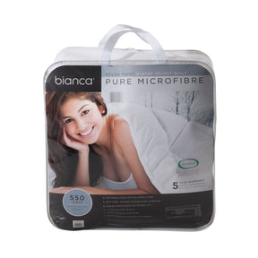 Diamond quilted winter microfibre quilt in white with satin piping on a made queen bed