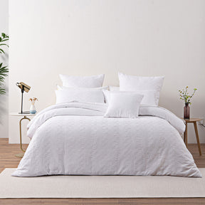 Chambord white chenille quilt cover set with geometric square design on a bed