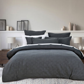 Chenonceau charcoal cotton jacquard quilt cover set with diamond pattern on a bed