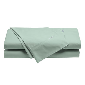 Norcia sage 300TC cotton percale sheet set on a bed