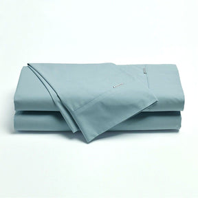 Norcia steel blue 300TC cotton percale sheet set on a bed