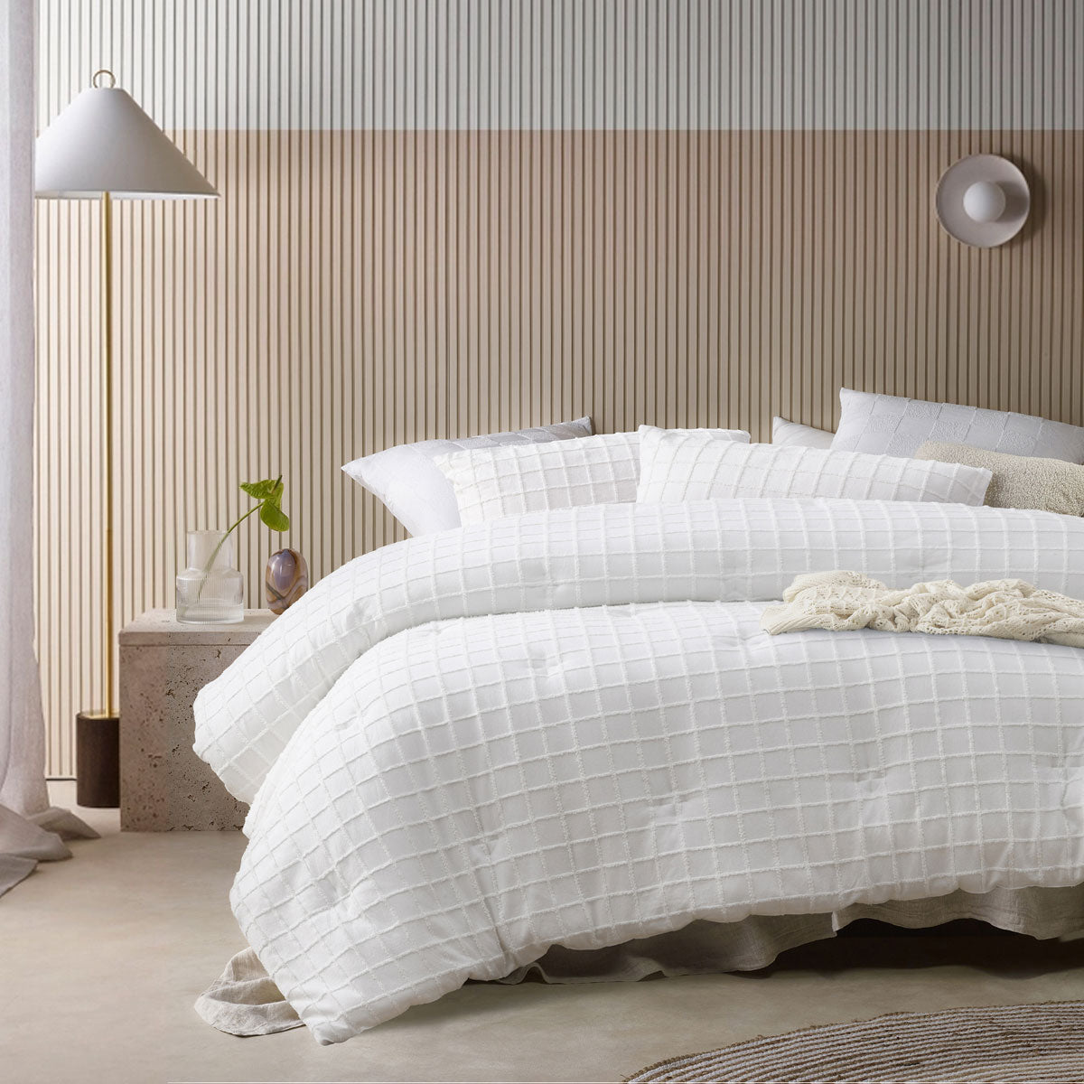 White comforter set with a tonal geometric parquet print and two pillowcases on a queen bed