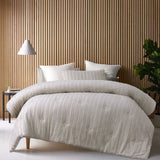 Natural toned comforter set with a soft tonal geometric pattern and two pillowcases on a queen bed