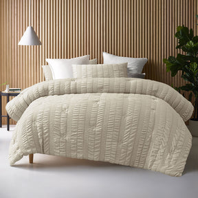Compton Abdale natural seersucker comforter set on a Queen bed with two pillowcases