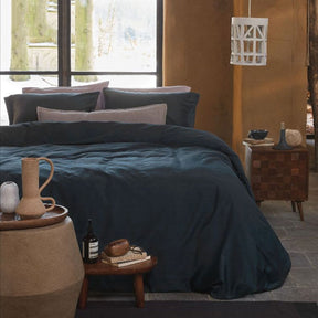 Montsoreau dark blue cotton quilt cover set in a solid tone on a styled bed
