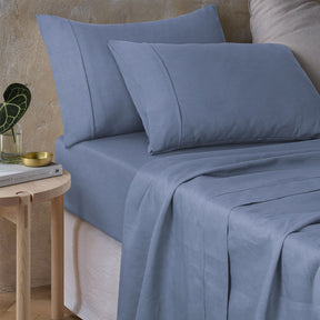 Pienza sky blue pure hemp sheet set on a calm coastal bed