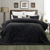 Channel stitched charcoal faux fur comforter set with two pillowcases on a queen bed