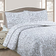 Slimbridge grey and white foliage jacquard coverlet on a Queen bed