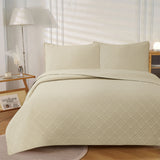 Frampton on Severn beige embossed reversible coverlet on a Queen bed