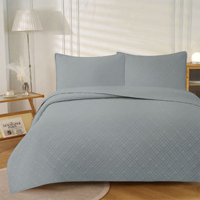 Dark grey ultrasonic embossed reversible coverlet with two pillowcases on a King bed