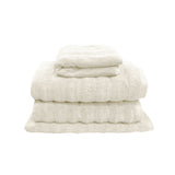Snow white four piece cotton towel set with two bath towels, hand towel and bath mat