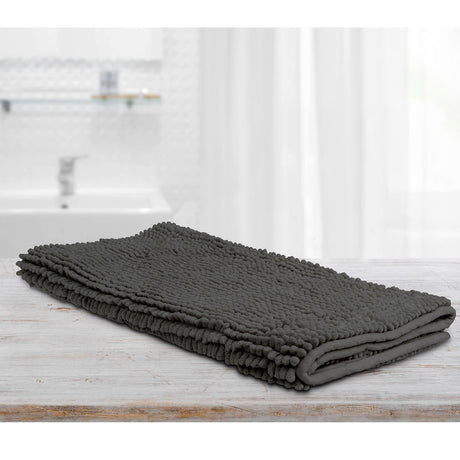 Large charcoal microfibre bath mat with a toggle applique design on a bathroom floor