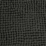 Charcoal microfibre bath mat shown beside a bath with its non slip backing on tile