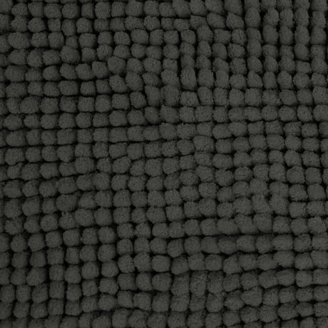 Charcoal microfibre bath mat shown beside a bath with its non slip backing on tile