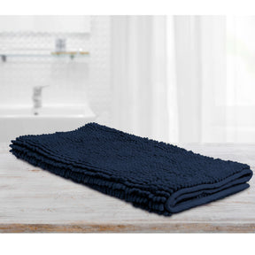 Large navy microfibre bath mat with a toggle applique design on a bathroom floor