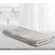 Large silver microfibre bath mat with a toggle applique design on a bathroom floor