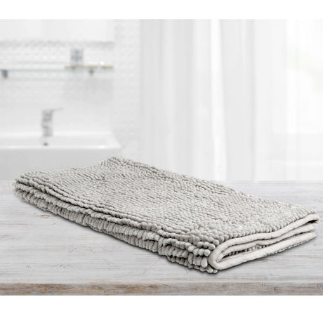 Large silver microfibre bath mat with a toggle applique design on a bathroom floor