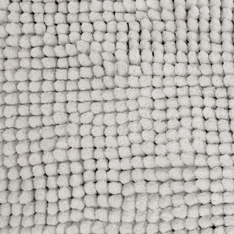Silver microfibre bath mat shown beside a bath with its non slip backing on tile