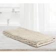 Stone microfibre bath mat with applique design laid on a tiled bathroom floor