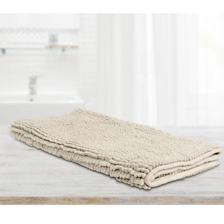 Stone microfibre bath mat with applique design laid on a tiled bathroom floor