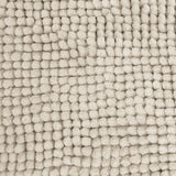 Stone bath mat shown beside a bath with its non slip backing