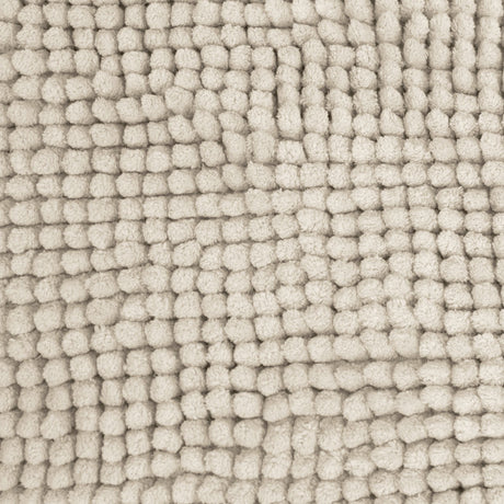 Stone bath mat shown beside a bath with its non slip backing