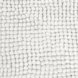 White bath mat shown beside a bath with its non slip backing