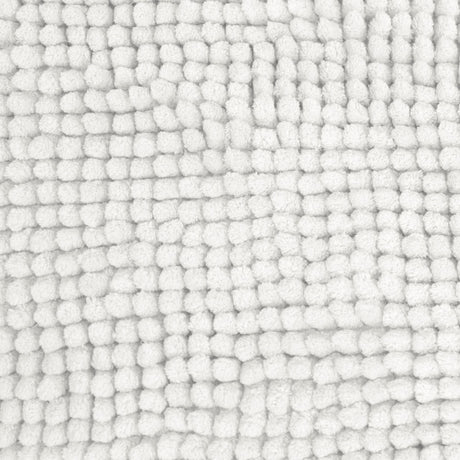 White bath mat shown beside a bath with its non slip backing