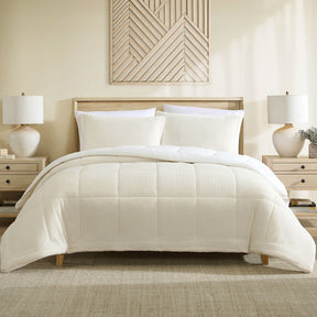 Cream velvet comforter set with a sherpa reverse and two pillowcases on a made bed