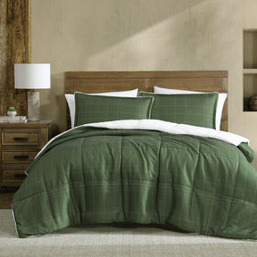 Colesbourne deep khaki stitch print comforter with plush sherpa reverse on a Queen bed
