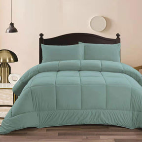 Aqua mink flannel comforter with quilted squares and two pillowcases on a King bed