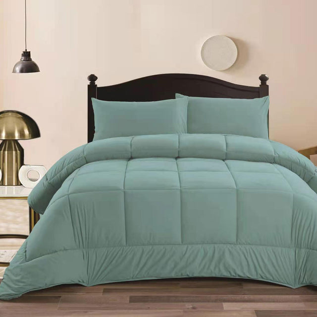 Aqua mink flannel comforter with quilted squares and two pillowcases on a King bed
