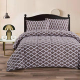 Charcoal and white mink flannel comforter with a diamond flower pattern and two pillowcases on a King bed