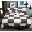 Cam charcoal and white check comforter set on a Queen bed