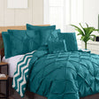 Teal seven piece comforter set with crisp pinch pleat detailing on a queen bed