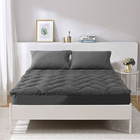 Aberystwyth 1000GSM charcoal mattress topper king on a bed