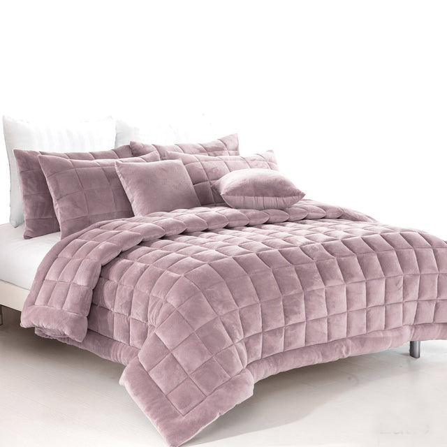Blush faux mink quilt with quilted boxes and two pillowcases on a Queen bed