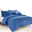 Denim faux mink quilt with quilted boxes and two pillowcases on a Queen bed