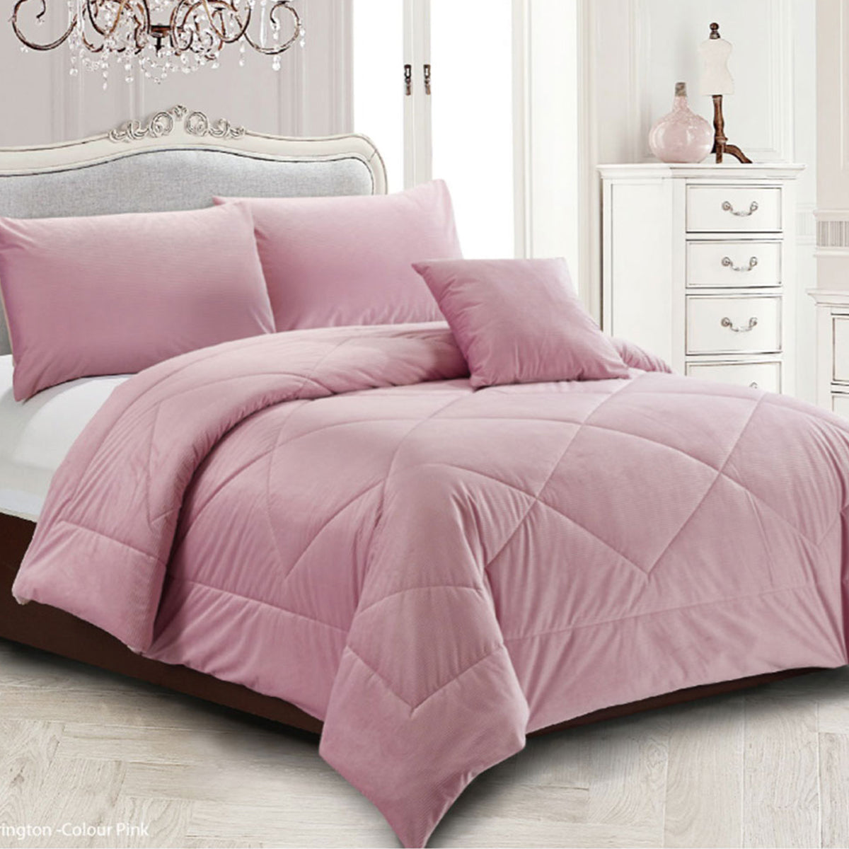 Pink diamond quilted quilt with two pillowcases on a Queen bed
