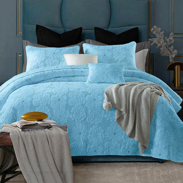 Aqua cotton rich lightly quilted coverlet set with two pillow shams on a queen bed