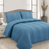 Arlington blue pintuck quilted coverlet set on a Queen bed with matching pillowcases